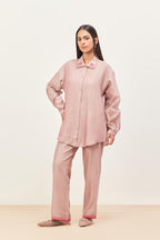 Lilac silk chanderi shirt with all-over pin tucks, highlighted with contrast beads in the front, paired with Lilac silk chanderi straight pants detailed with multi colored applique, highlighted with sequins work at bottom hem.