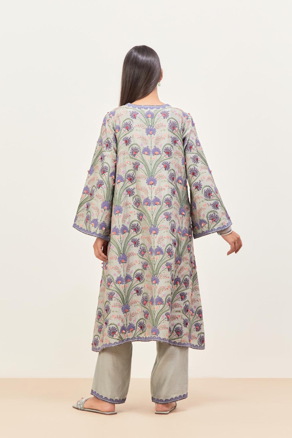 Bluish Grey short A-line silk chanderi kurta set, fully embroidered with appliqué flowers, highlighted with aari thread work and silk tassels.
