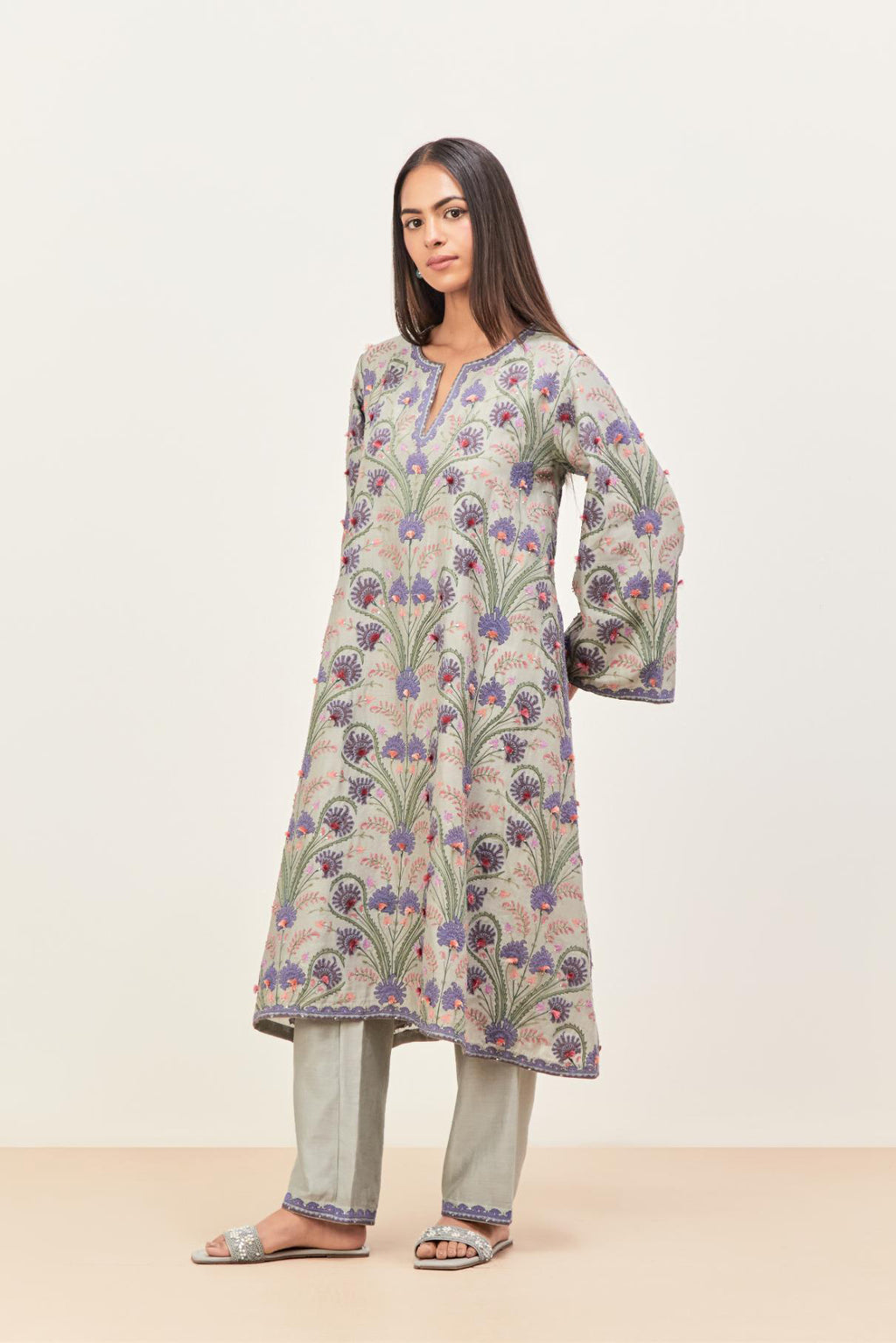 Bluish Grey short A-line silk chanderi kurta set, fully embroidered with appliqué flowers, highlighted with aari thread work and silk tassels.