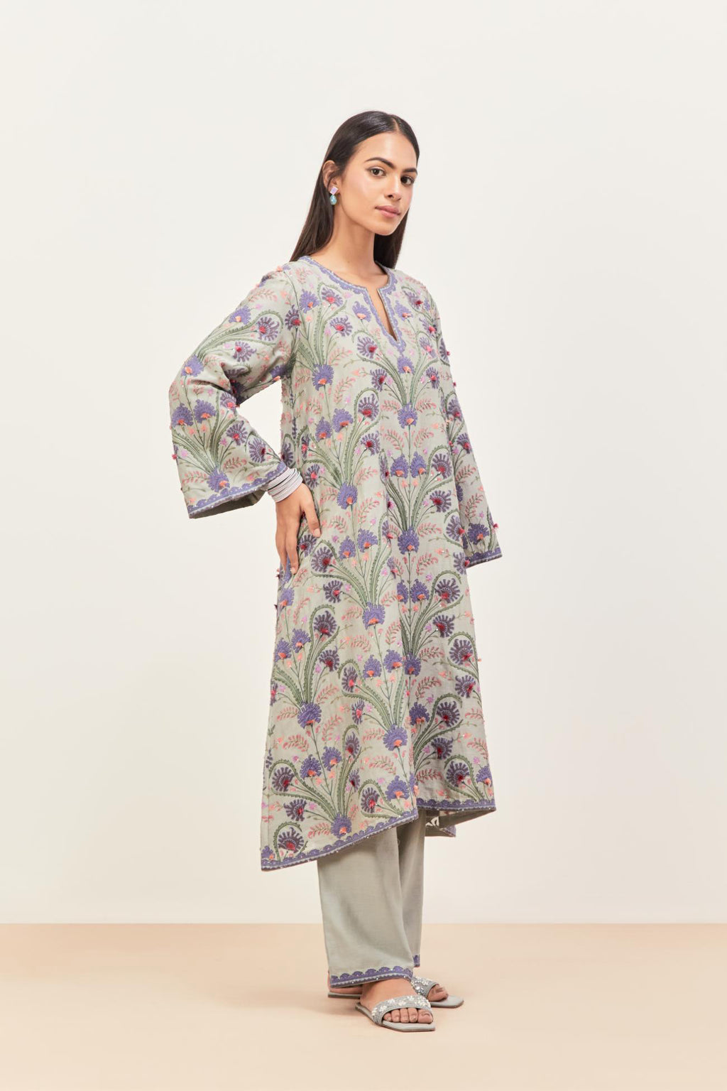 Bluish Grey short A-line silk chanderi kurta set, fully embroidered with appliqué flowers, highlighted with aari thread work and silk tassels.