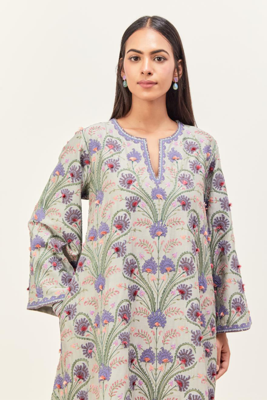 Bluish Grey short A-line silk chanderi kurta set, fully embroidered with appliqué flowers, highlighted with aari thread work and silk tassels.