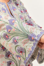 Bluish Grey short A-line silk chanderi kurta set, fully embroidered with appliqué flowers, highlighted with aari thread work and silk tassels.