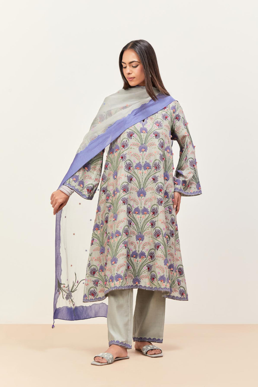 Bluish Grey short A-line silk chanderi kurta set, fully embroidered with appliqué flowers, highlighted with aari thread work and silk tassels.