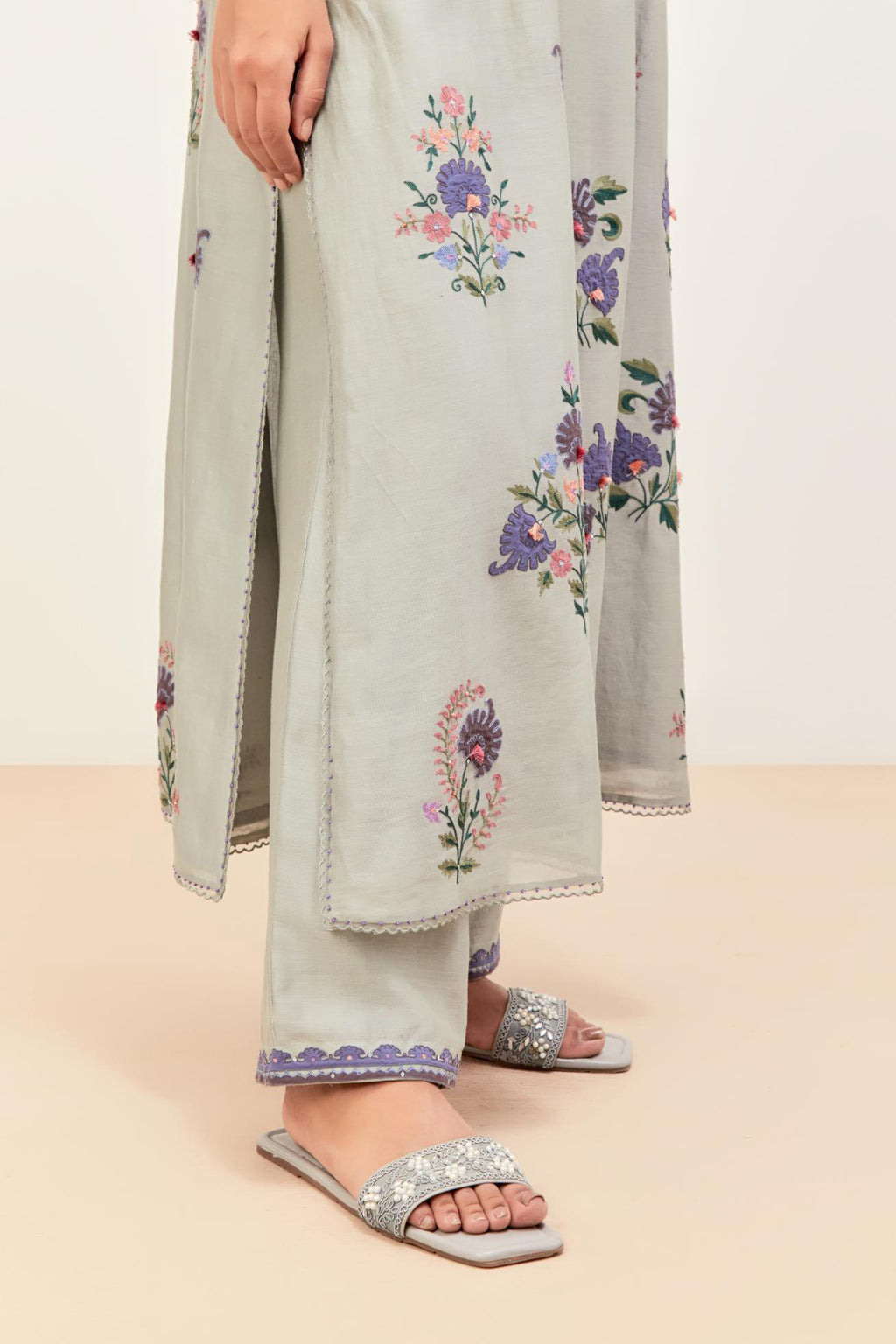 Bluish Grey silk chanderi kurta set with pin tucks at yoke and all-over applique, highlighted with aari threadwork & sequins.