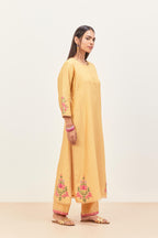 Yellow silk chanderi kurta set with pin tucks in the front & back and floral applique boota at sides, highlighted with aari threadwork & sequins.