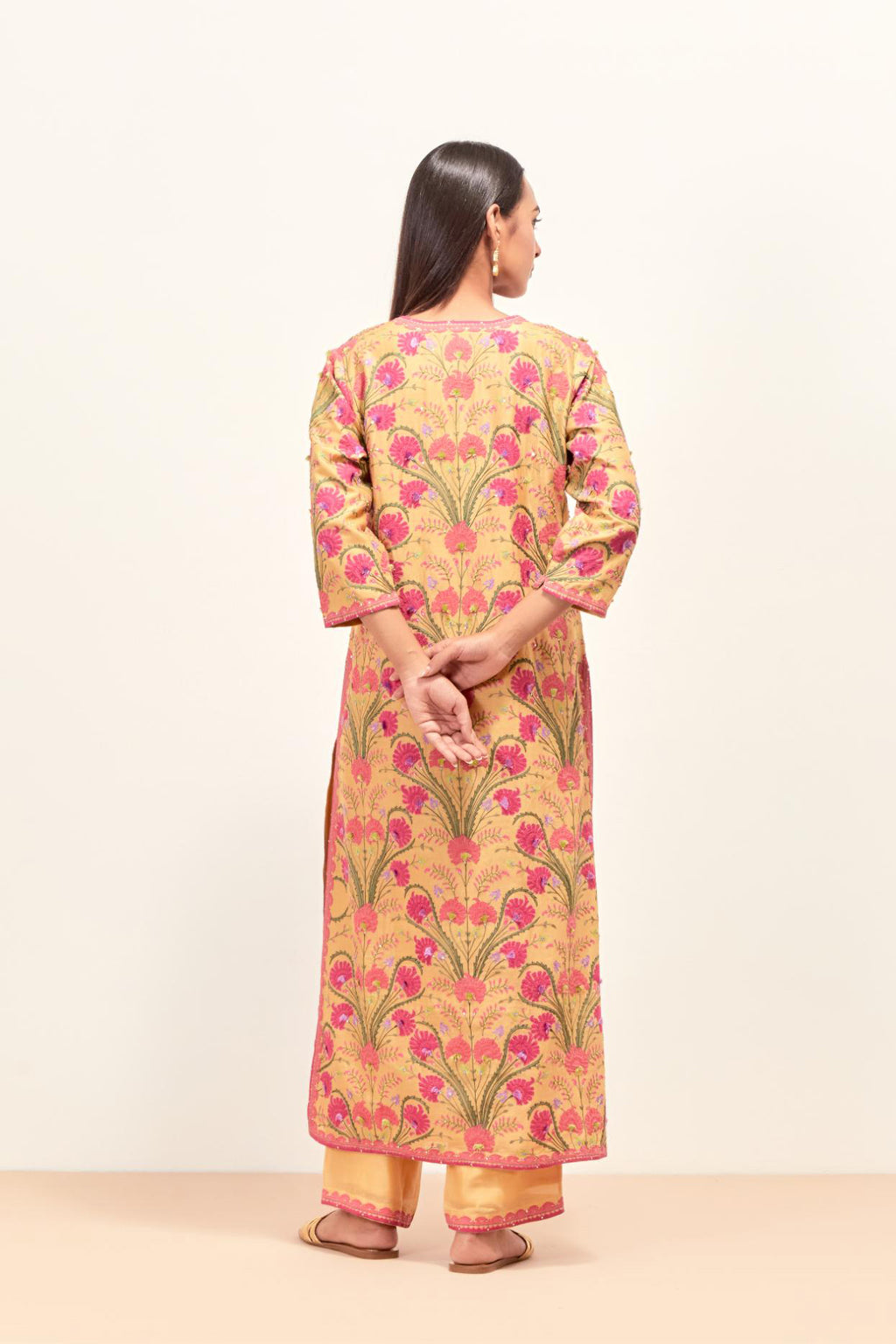 Yellow straight kurta set, fully embroidered with appliqué flowers, multi-colored aari threadwork and silk tassels.