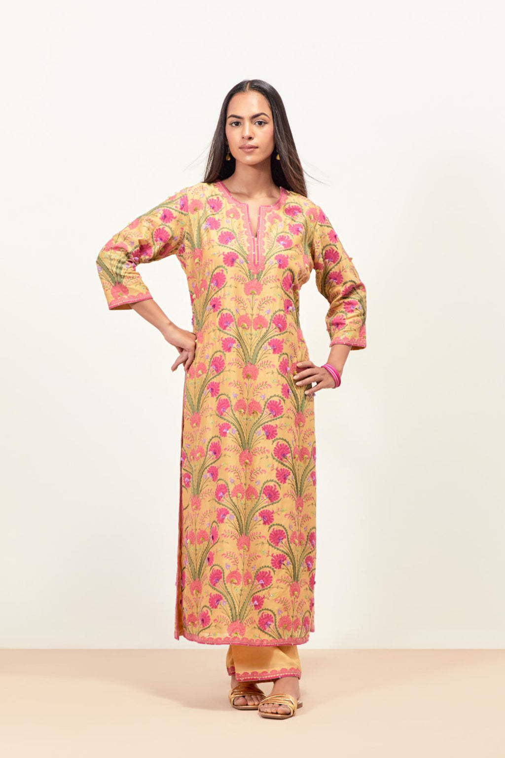 Yellow straight kurta set, fully embroidered with appliqué flowers, multi-colored aari threadwork and silk tassels.