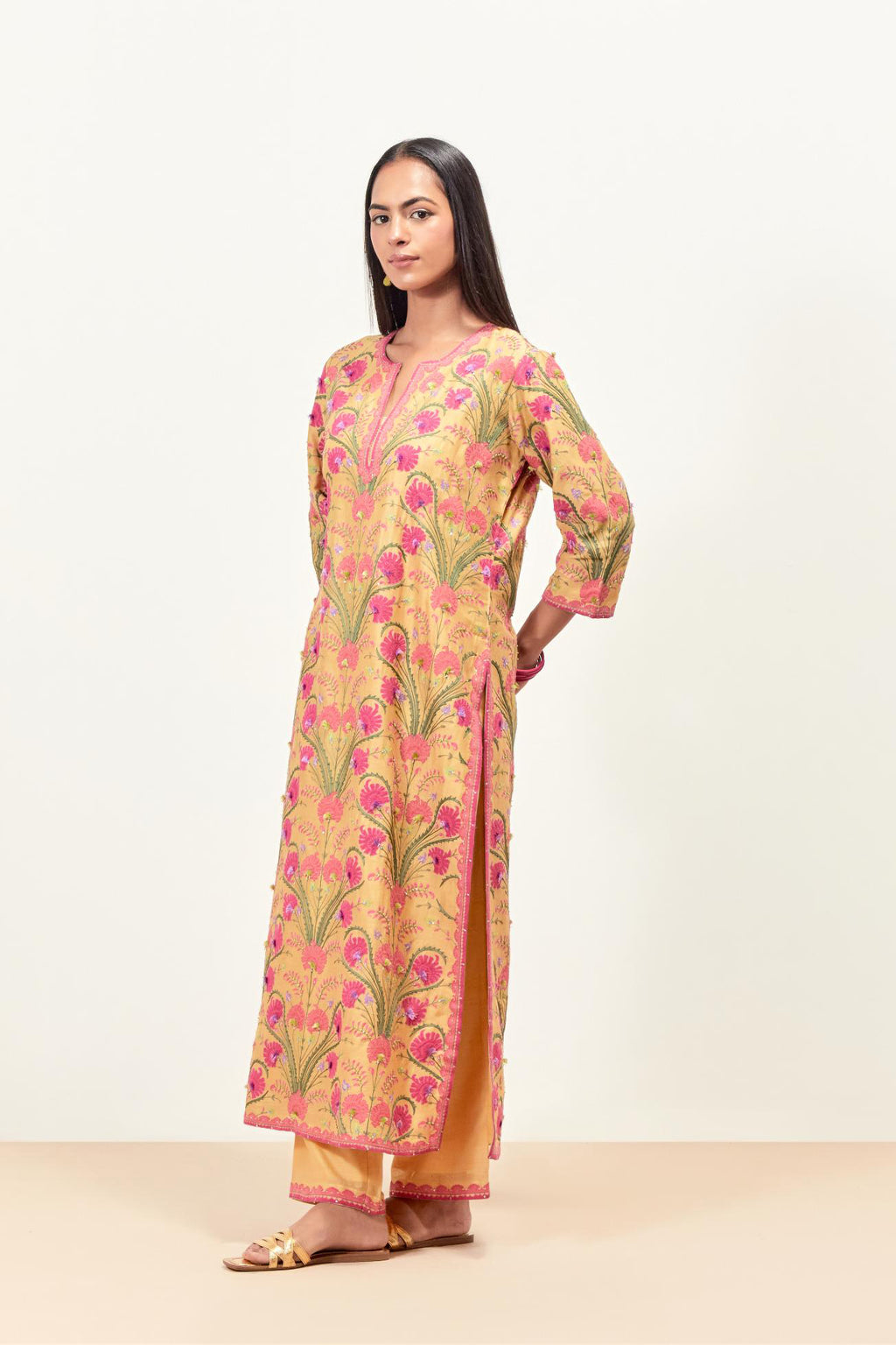 Yellow straight kurta set, fully embroidered with appliqué flowers, multi-colored aari threadwork and silk tassels.