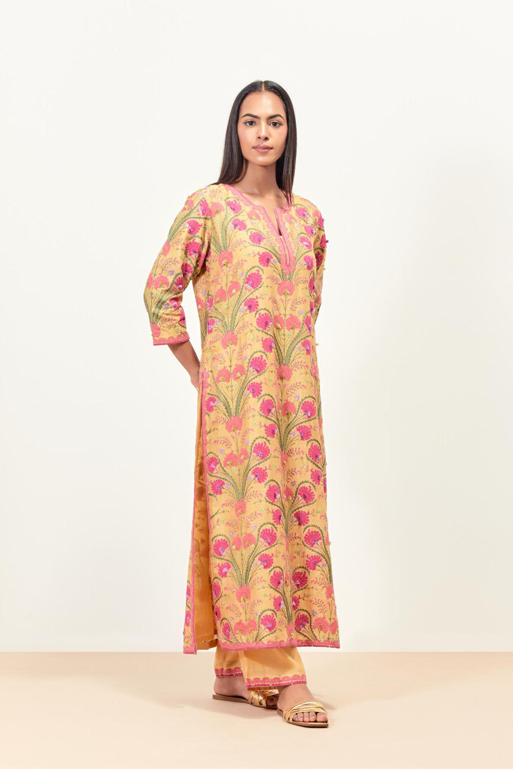 Yellow straight kurta set, fully embroidered with appliqué flowers, multi-colored aari threadwork and silk tassels.