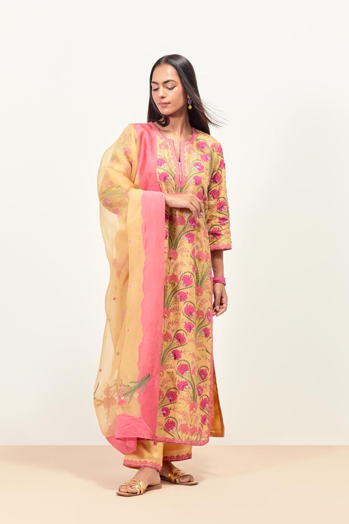 Yellow straight kurta set, fully embroidered with appliqué flowers, multi-colored aari threadwork and silk tassels.