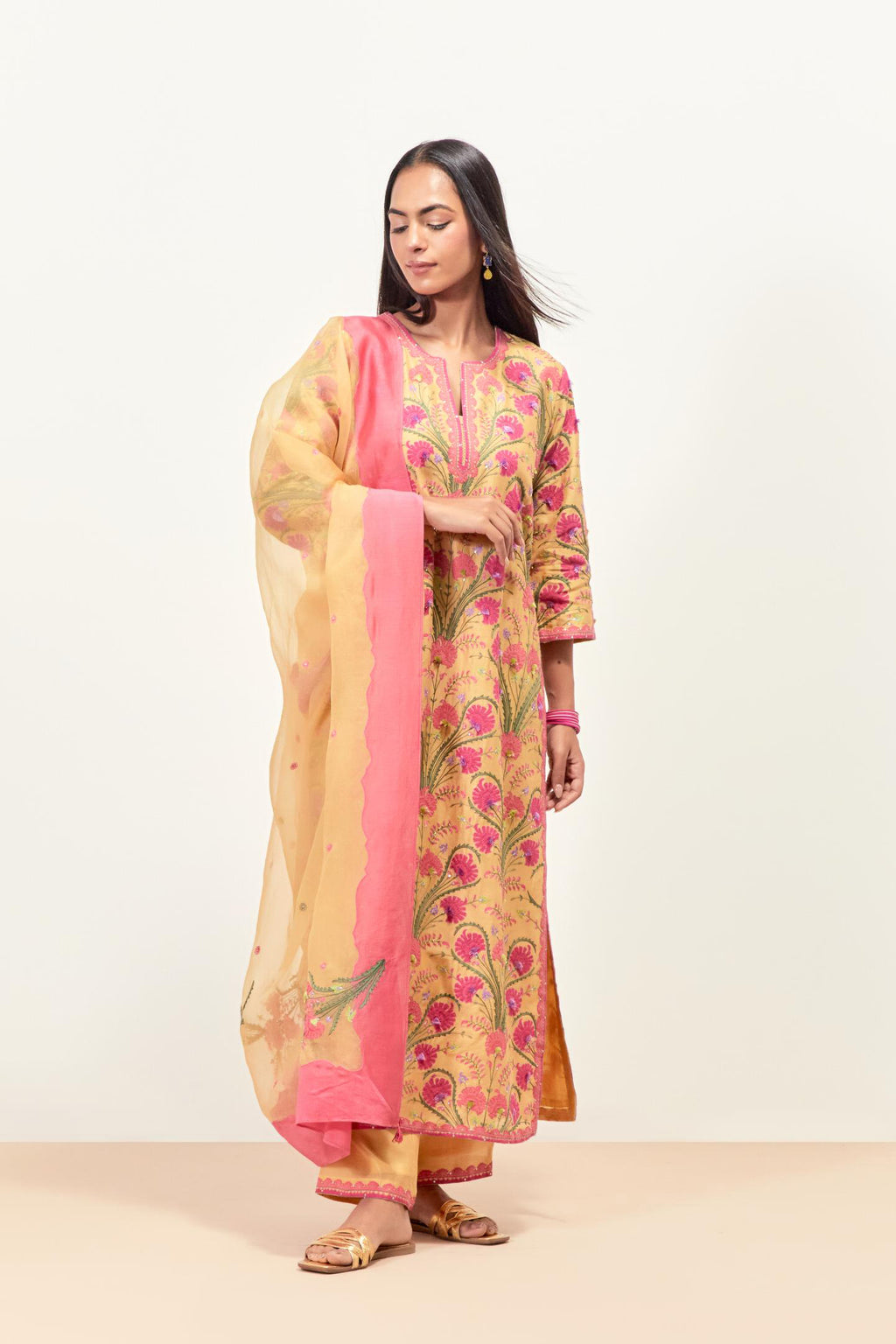Yellow straight kurta set, fully embroidered with appliqué flowers, multi-colored aari threadwork and silk tassels.