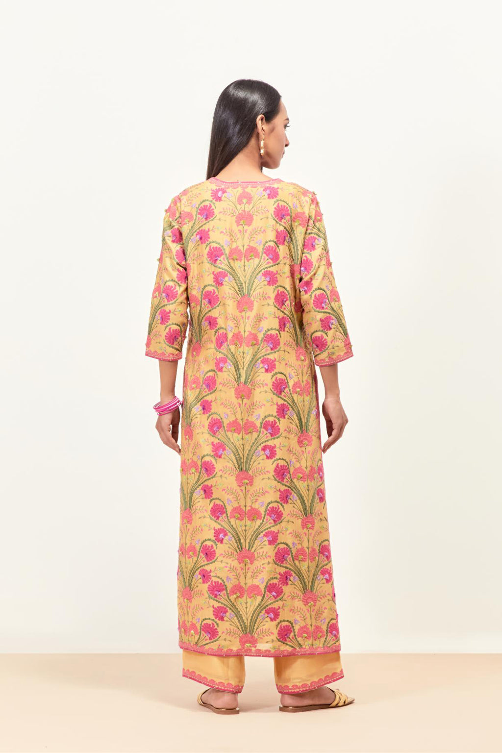 Yellow straight kurta set, fully embroidered with appliqué flowers, multi-colored aari threadwork and silk tassels.