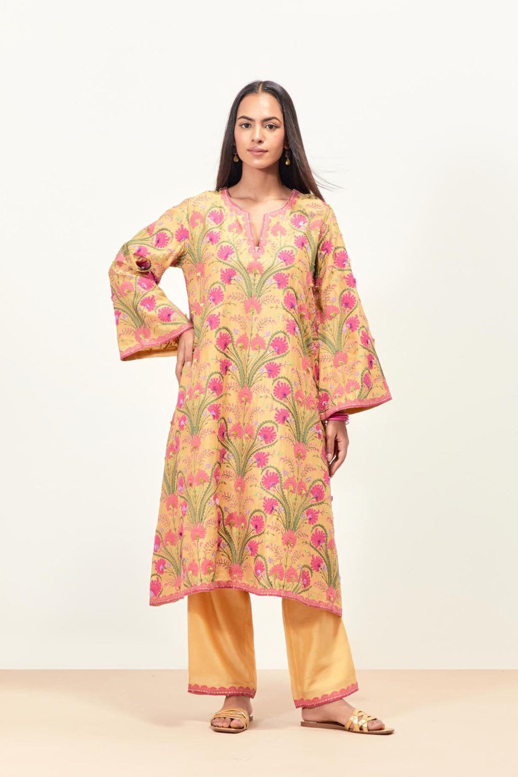 Yellow short A-line silk chanderi kurta set, fully embroidered with appliqué flowers, highlighted with aari thread work and silk tassels.