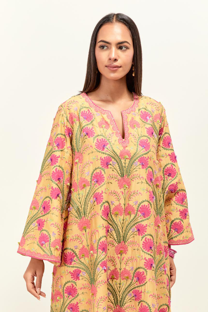 Yellow short A-line silk chanderi kurta set, fully embroidered with appliqué flowers, highlighted with aari thread work and silk tassels.