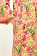 Yellow short A-line silk chanderi kurta set, fully embroidered with appliqué flowers, highlighted with aari thread work and silk tassels.