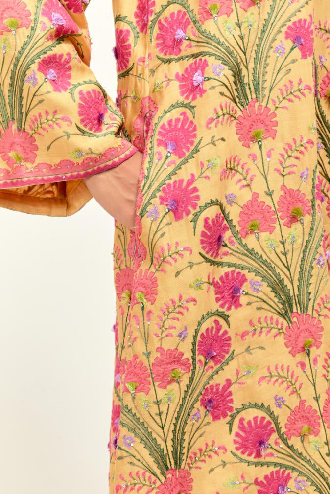 Yellow short A-line silk chanderi kurta set, fully embroidered with appliqué flowers, highlighted with aari thread work and silk tassels.
