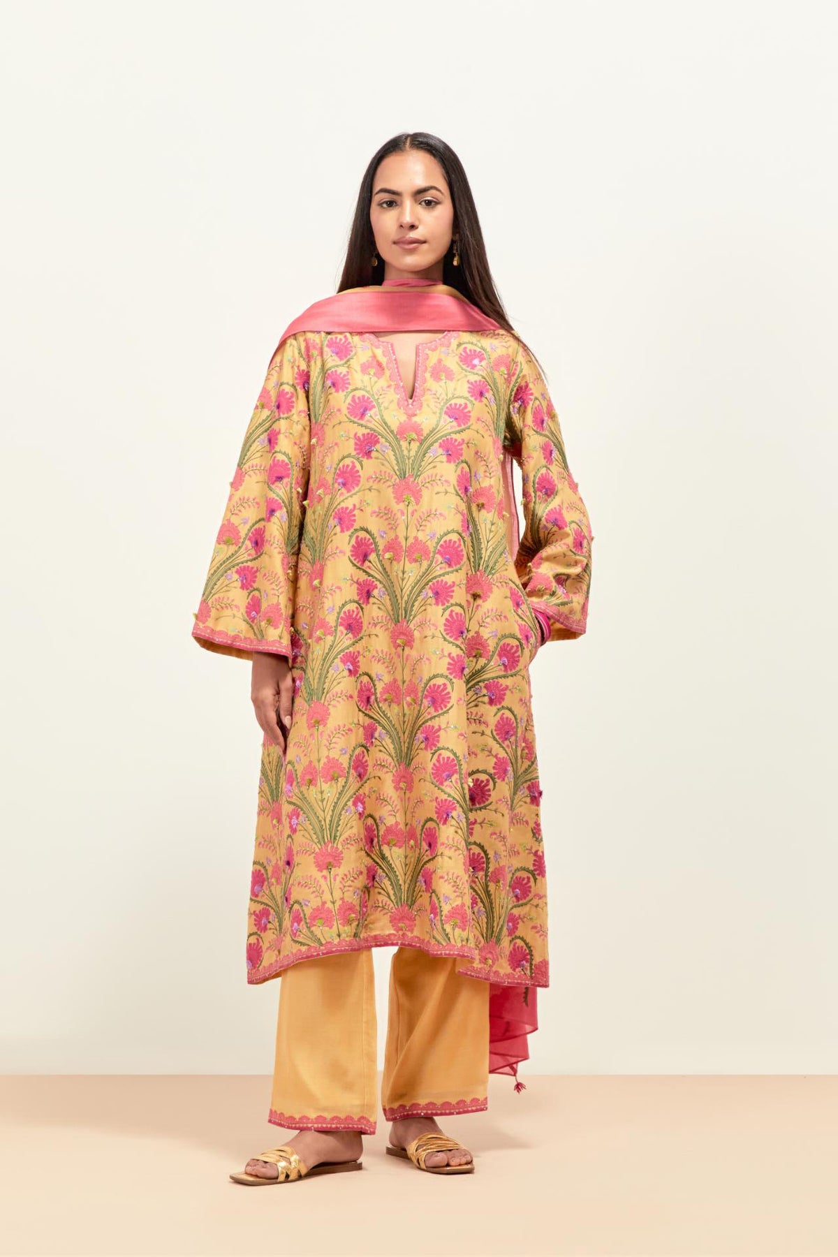 Yellow short A-line silk chanderi kurta set, fully embroidered with appliqué flowers, highlighted with aari thread work and silk tassels.