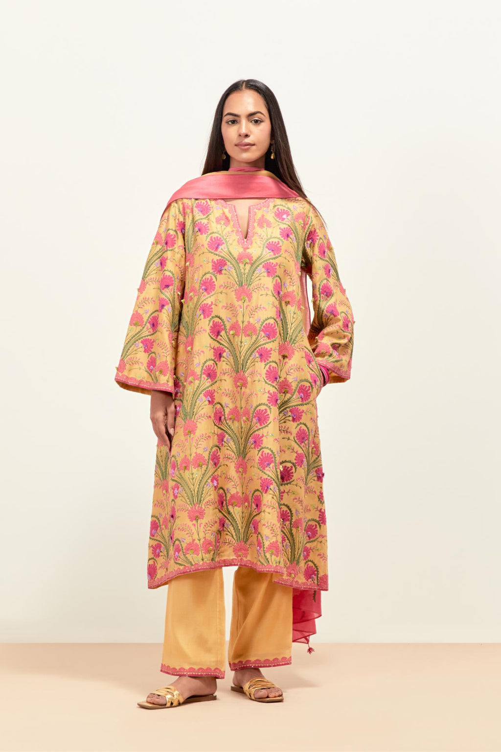 Yellow short A-line silk chanderi kurta set, fully embroidered with appliqué flowers, highlighted with aari thread work and silk tassels.