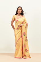 Yellow silk chanderi saree with all-over applique floral boota, highlighted with aari thread work and sequins, paired with yellow silk chanderi blouse with pin tucks in front, highlighted with bead work.