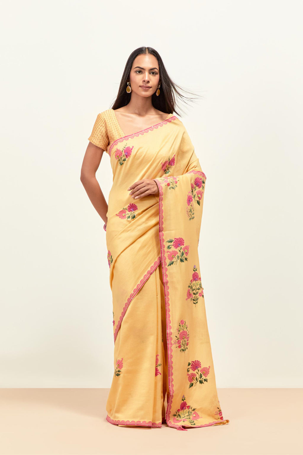 Yellow silk chanderi saree with all-over applique floral boota, highlighted with aari thread work and sequins, paired with yellow silk chanderi blouse with pin tucks in front, highlighted with bead work.