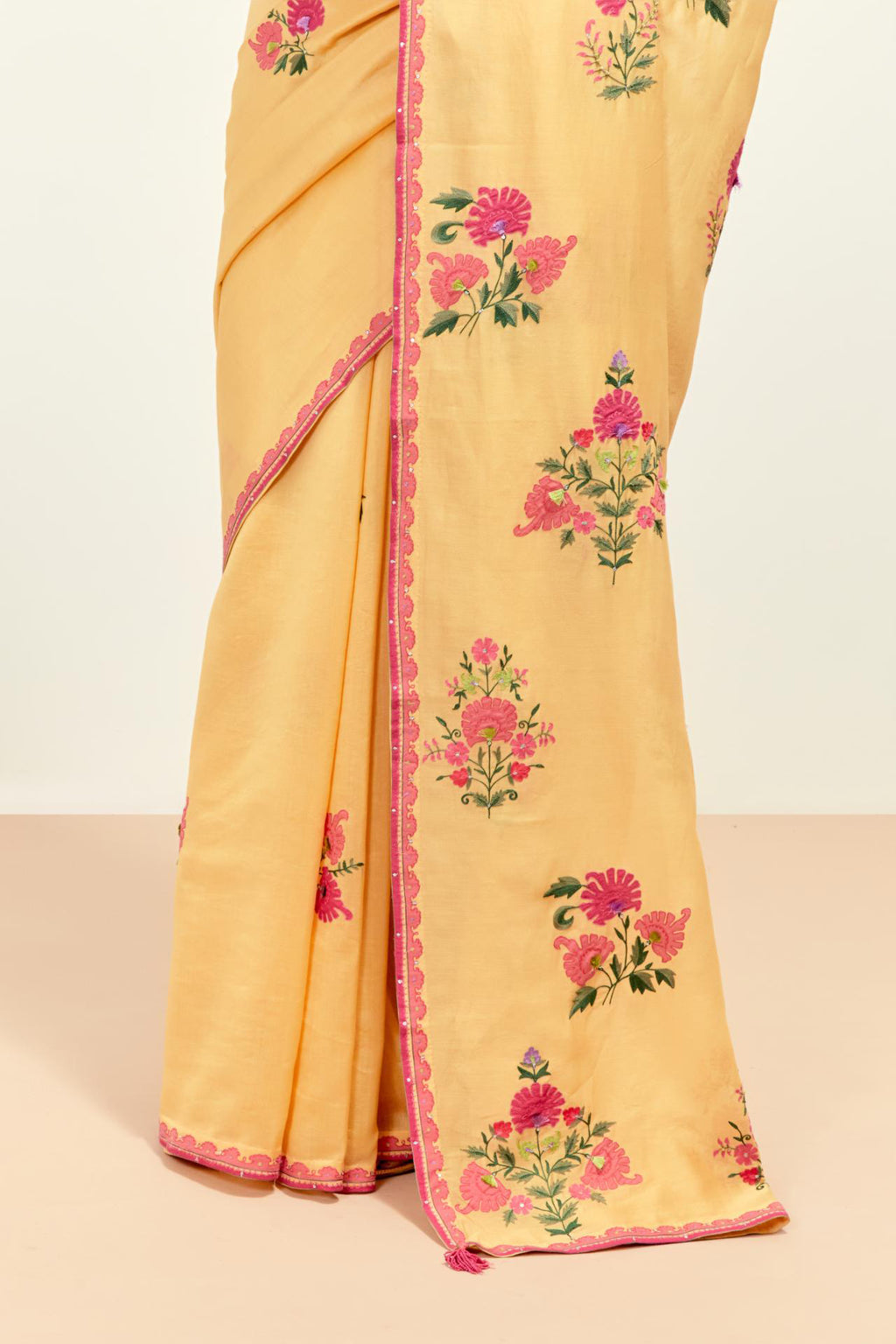 Yellow silk chanderi saree with all-over applique floral boota, highlighted with aari thread work and sequins, paired with yellow silk chanderi blouse with pin tucks in front, highlighted with bead work.