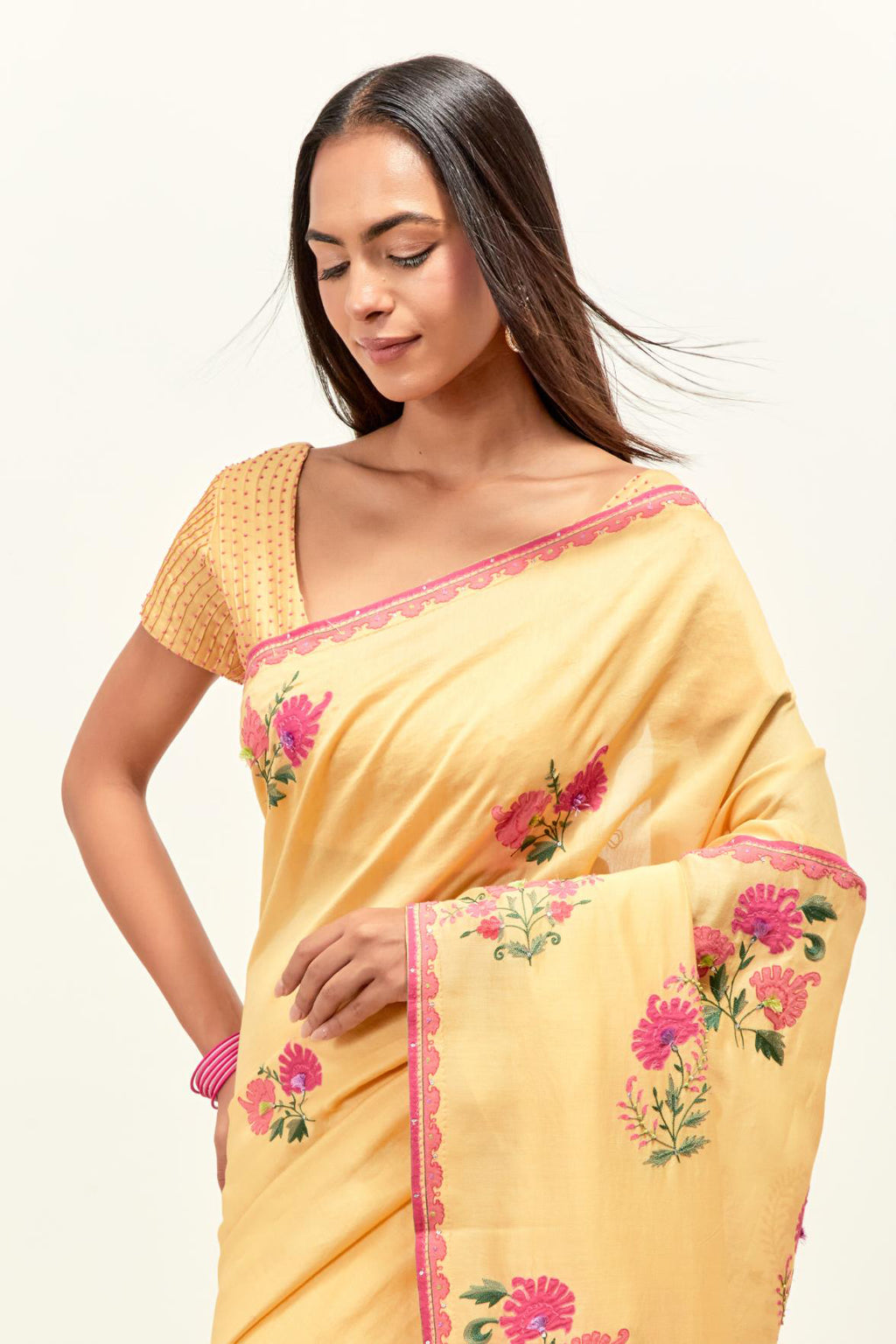 Yellow silk chanderi blouse with pin tucks in front, highlighted with bead work.