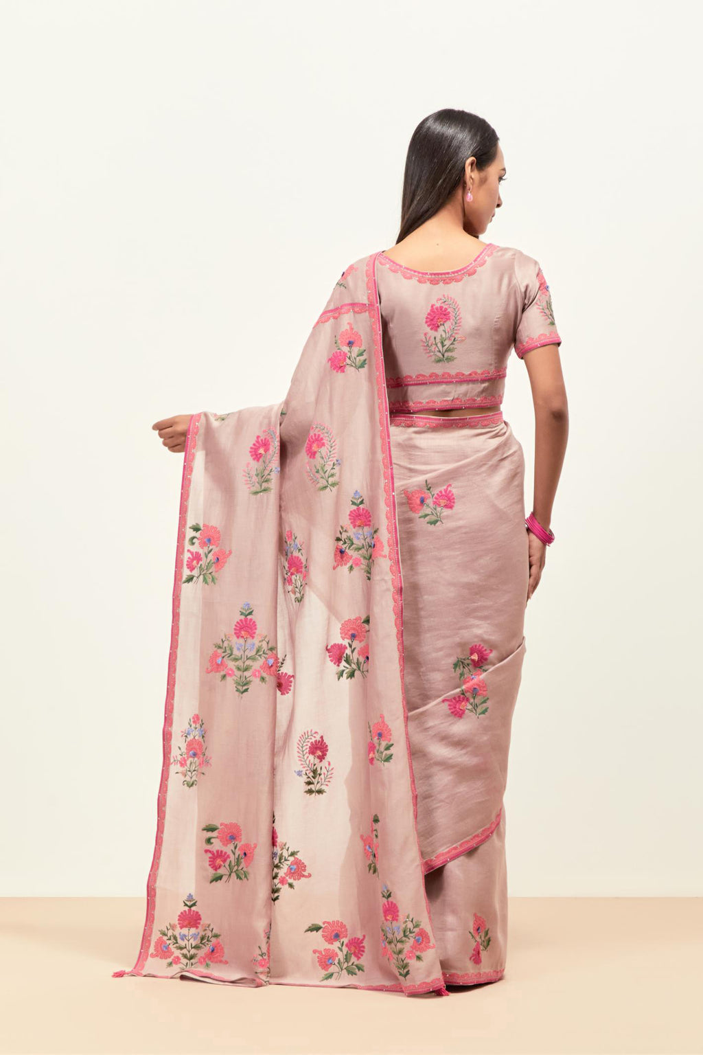 Lilac silk chanderi saree with all-over applique floral boota, highlighted with aari thread work and sequins, paired with lilac silk Chanderi blouse with appliqué work, further enhanced by delicate aari thread embroidery and sequins.