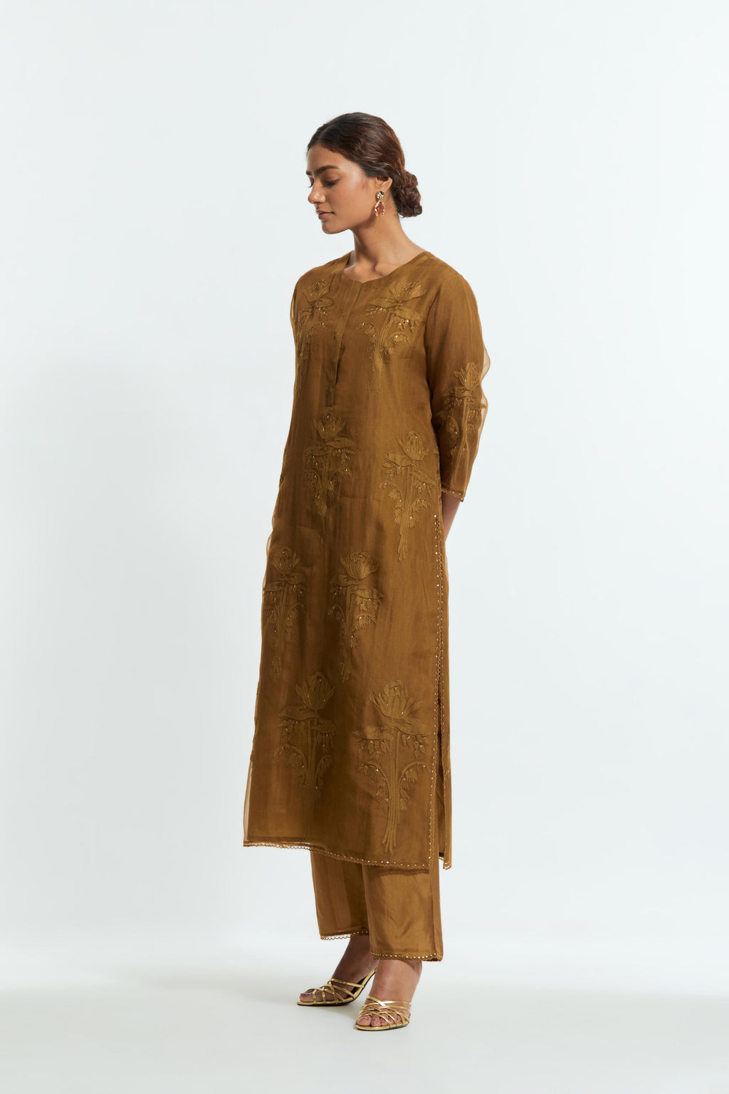 An olive straight silk organza kurta set featuring a round neckline, adorned with delicately placed silk floral boota appliqués and sequin work.