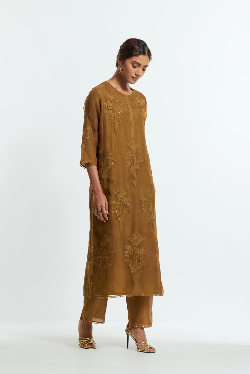 An olive straight silk organza kurta set featuring a round neckline, adorned with delicately placed silk floral boota appliqués and sequin work.