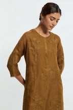 An olive straight silk organza kurta set featuring a round neckline, adorned with delicately placed silk floral boota appliqués and sequin work.