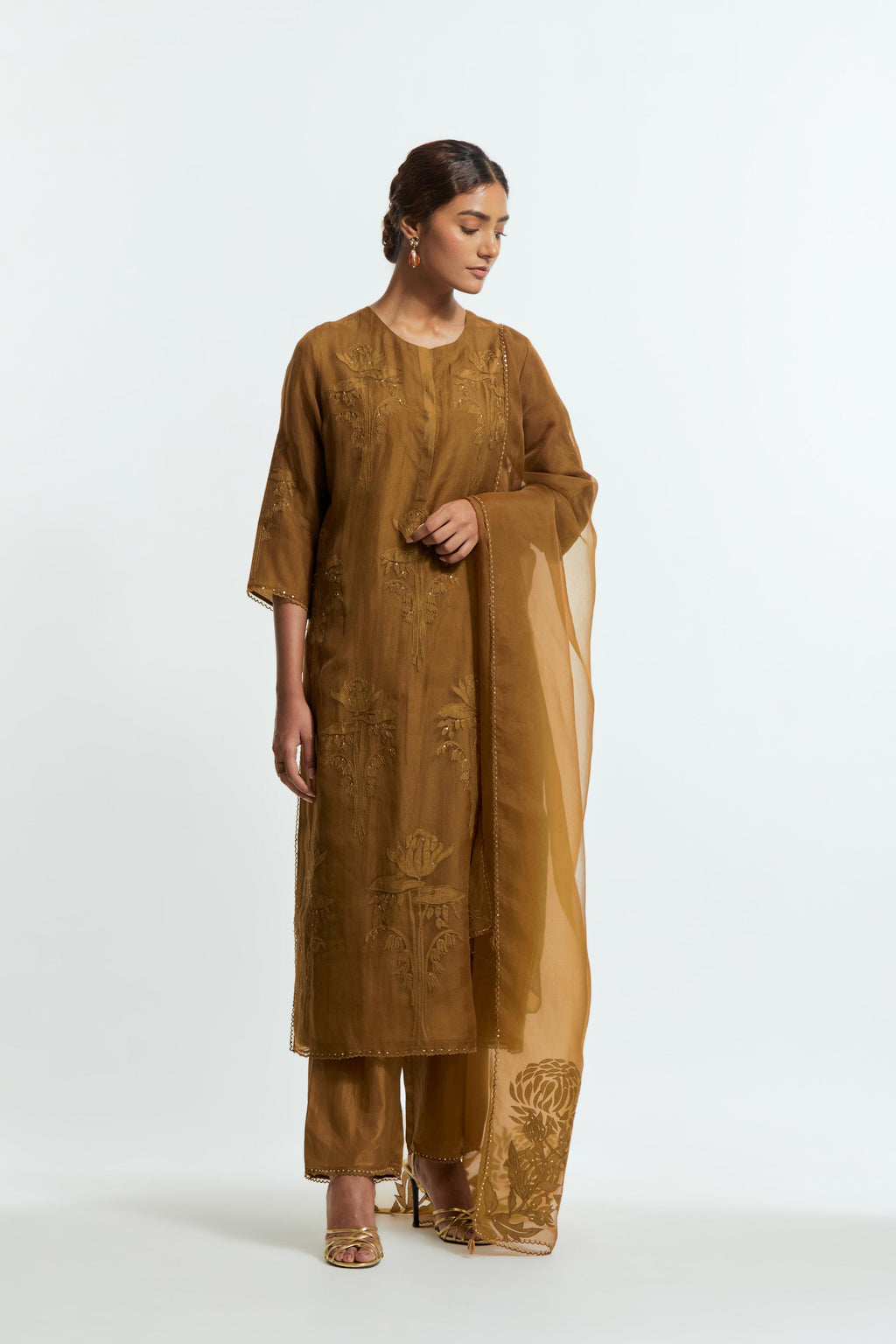An olive straight silk organza kurta set featuring a round neckline, adorned with delicately placed silk floral boota appliqués and sequin work.