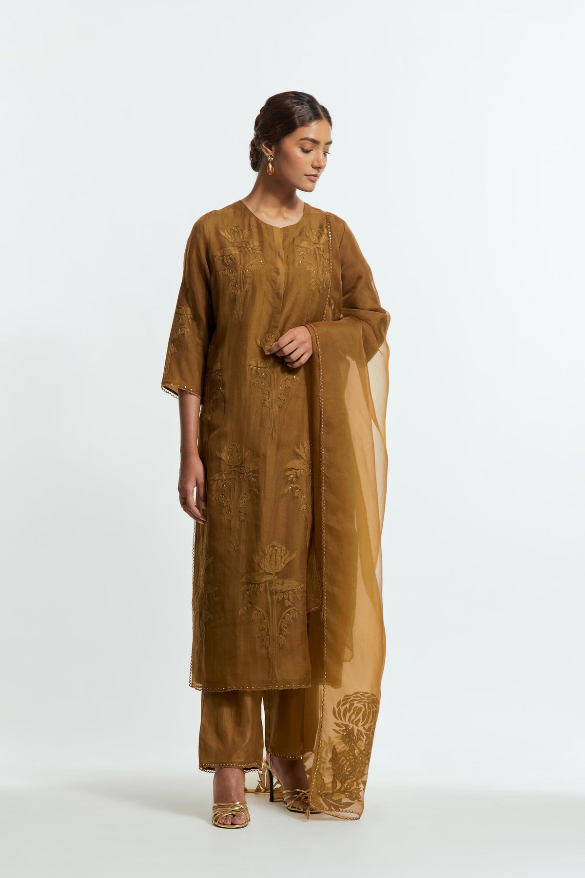 An olive straight silk organza kurta set featuring a round neckline, adorned with delicately placed silk floral boota appliqués and sequin work.
