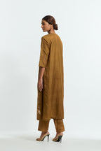 Olive silk straight kurta set adorned with appliqué chrysanthemum motifs along one side and both sleeves, delicately highlighted with fine French knots and subtle sequins.