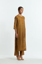 Olive silk straight kurta set adorned with appliqué chrysanthemum motifs along one side and both sleeves, delicately highlighted with fine French knots and subtle sequins.