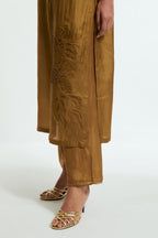 Olive silk straight kurta set adorned with appliqué chrysanthemum motifs along one side and both sleeves, delicately highlighted with fine French knots and subtle sequins.