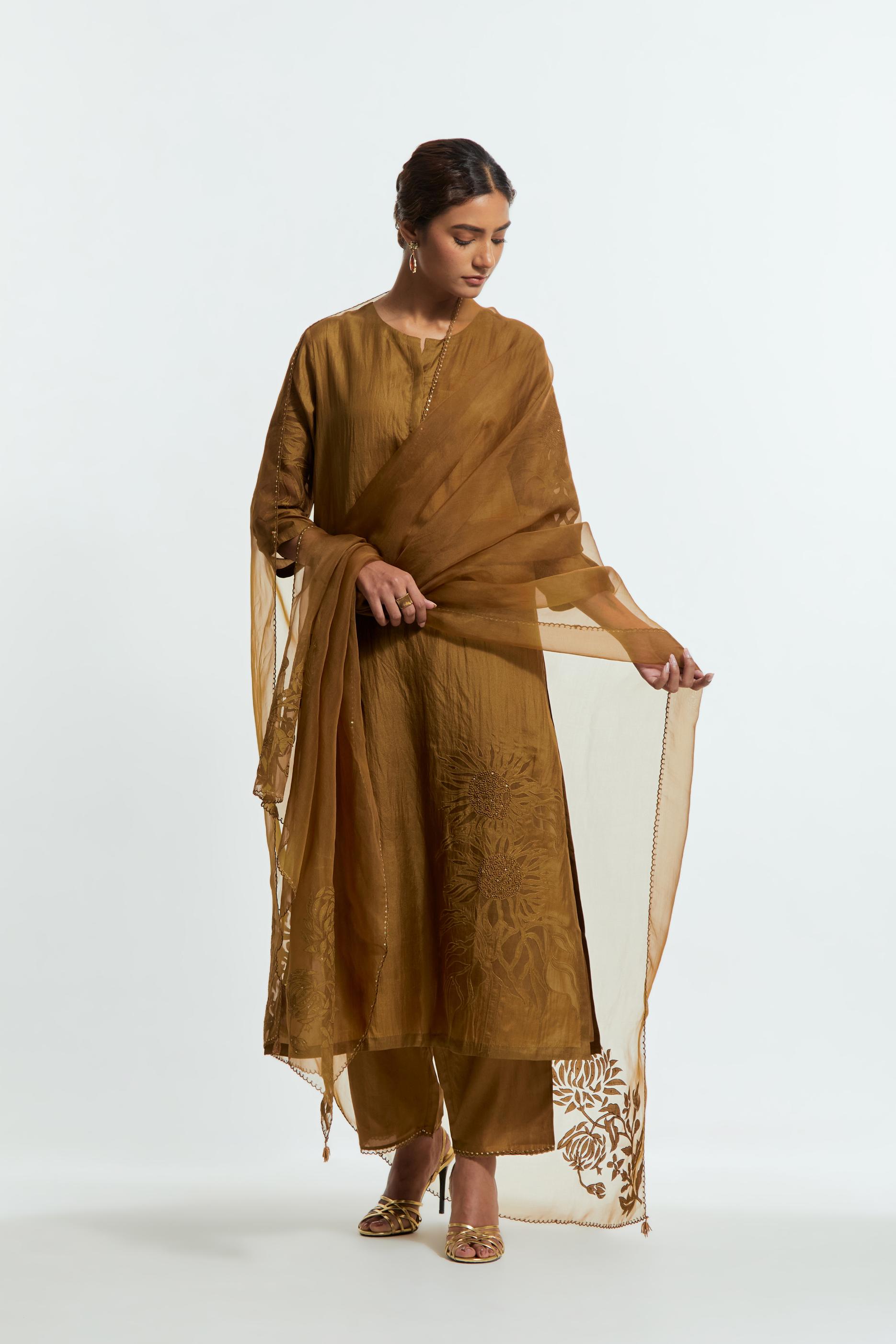 Olive silk straight kurta set adorned with appliqué chrysanthemum motifs along one side and both sleeves, delicately highlighted with fine French knots and subtle sequins.