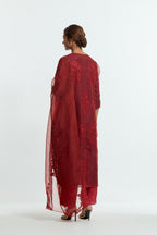A Red straight silk organza kurta set featuring a round neckline, adorned with delicately placed silk floral boota appliqués and sequin work.