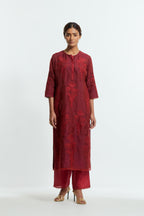A Red straight silk organza kurta set featuring a round neckline, adorned with delicately placed silk floral boota appliqués and sequin work.