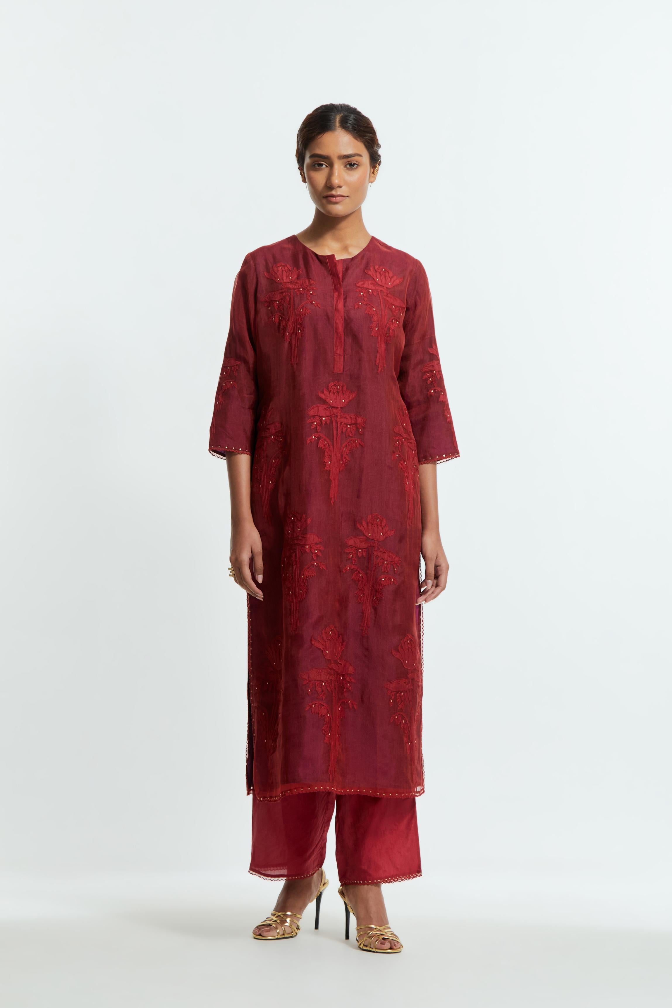A Red straight silk organza kurta set featuring a round neckline, adorned with delicately placed silk floral boota appliqués and sequin work.