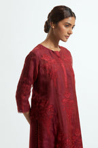 A Red straight silk organza kurta set featuring a round neckline, adorned with delicately placed silk floral boota appliqués and sequin work.
