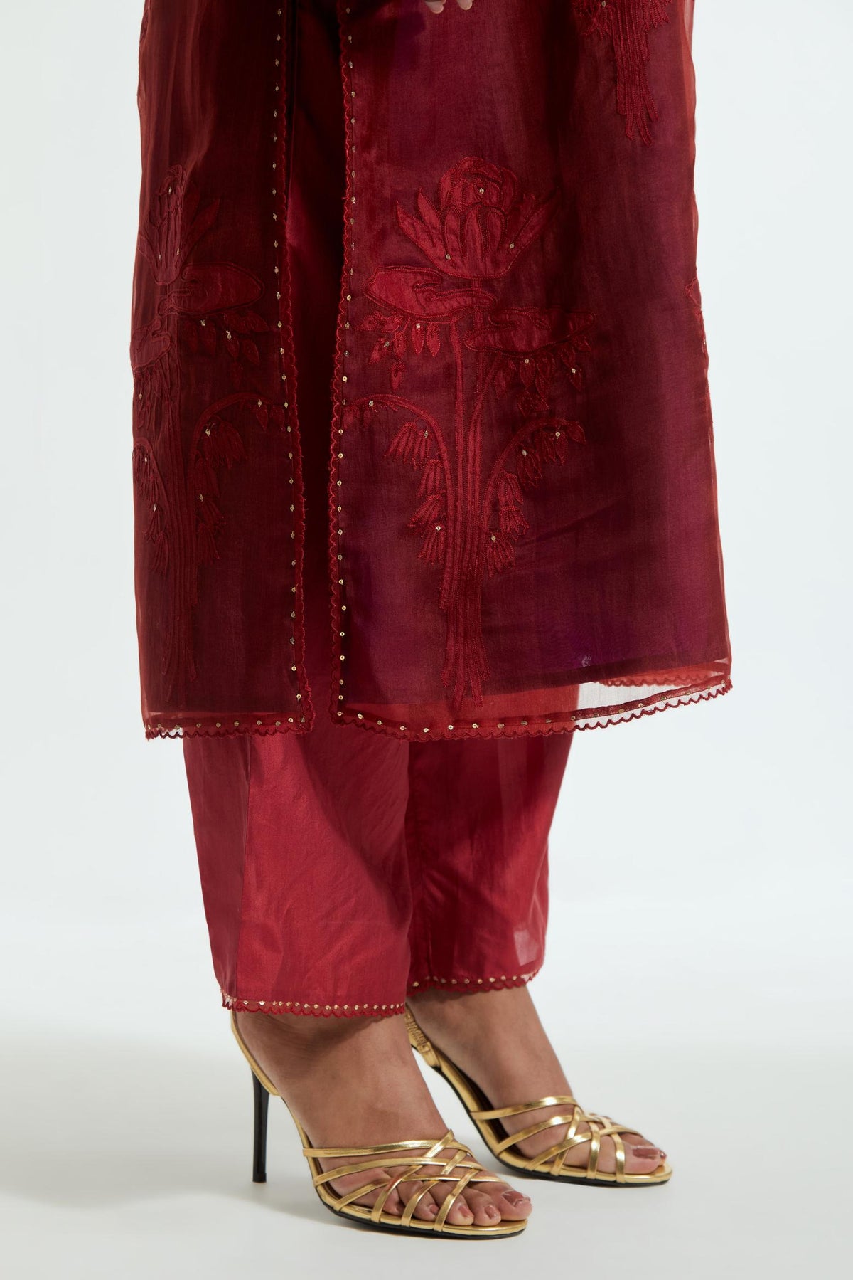 A Red straight silk organza kurta set featuring a round neckline, adorned with delicately placed silk floral boota appliqués and sequin work.