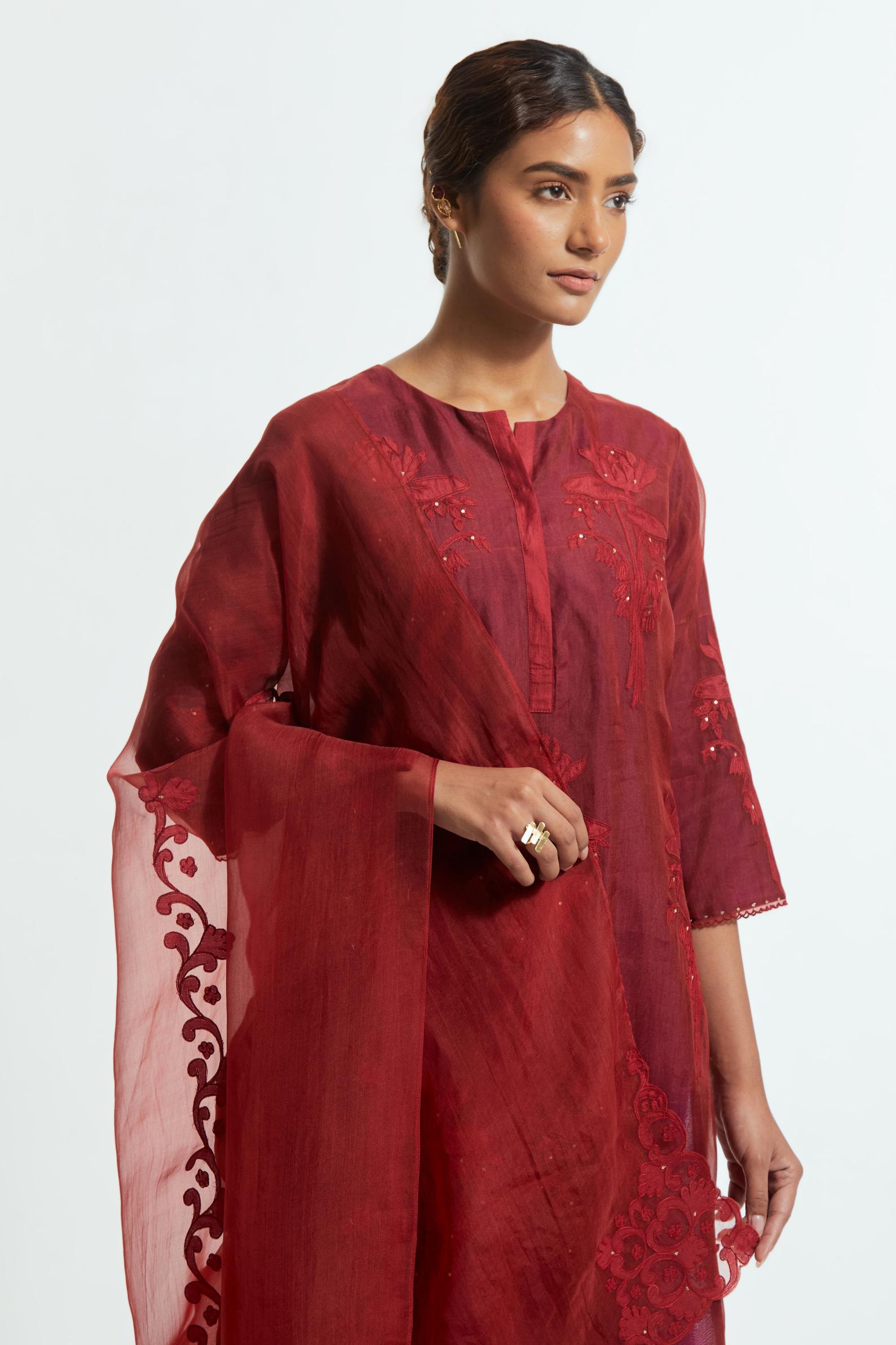 Red silk organza dupatta featuring silk appliqué embroidery, delicately highlighted with subtle sequins.