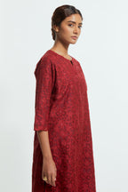 Red silk organza straight kurta set featuring an all-over silk appliqué trellis jaal, delicately highlighted with subtle sequins.