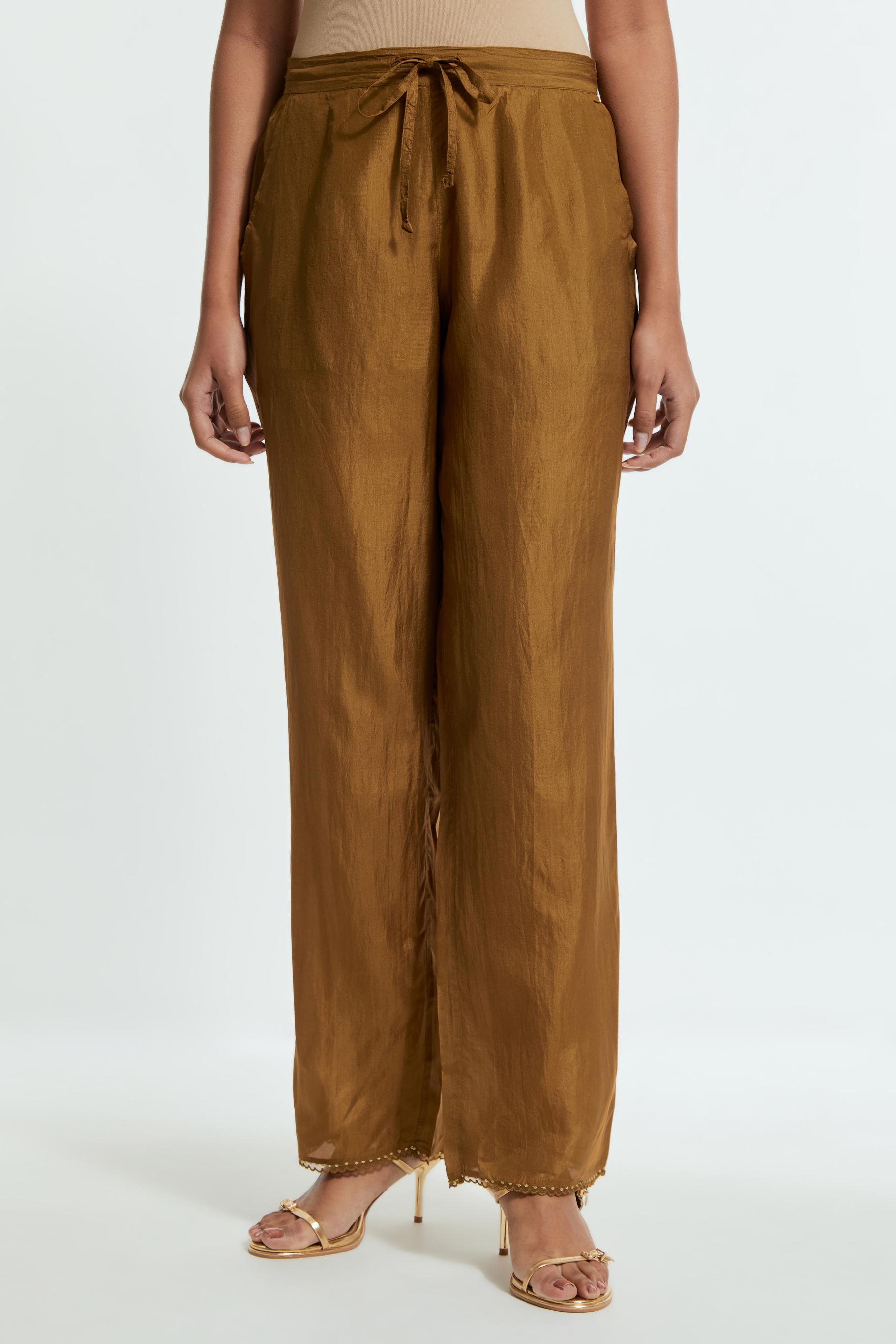 Olive silk straight pants detailed with scalloped organza edging at the hem, delicately highlighted with gold sequins work.