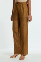 Olive silk straight pants detailed with scalloped organza edging at the hem, delicately highlighted with gold sequins work.