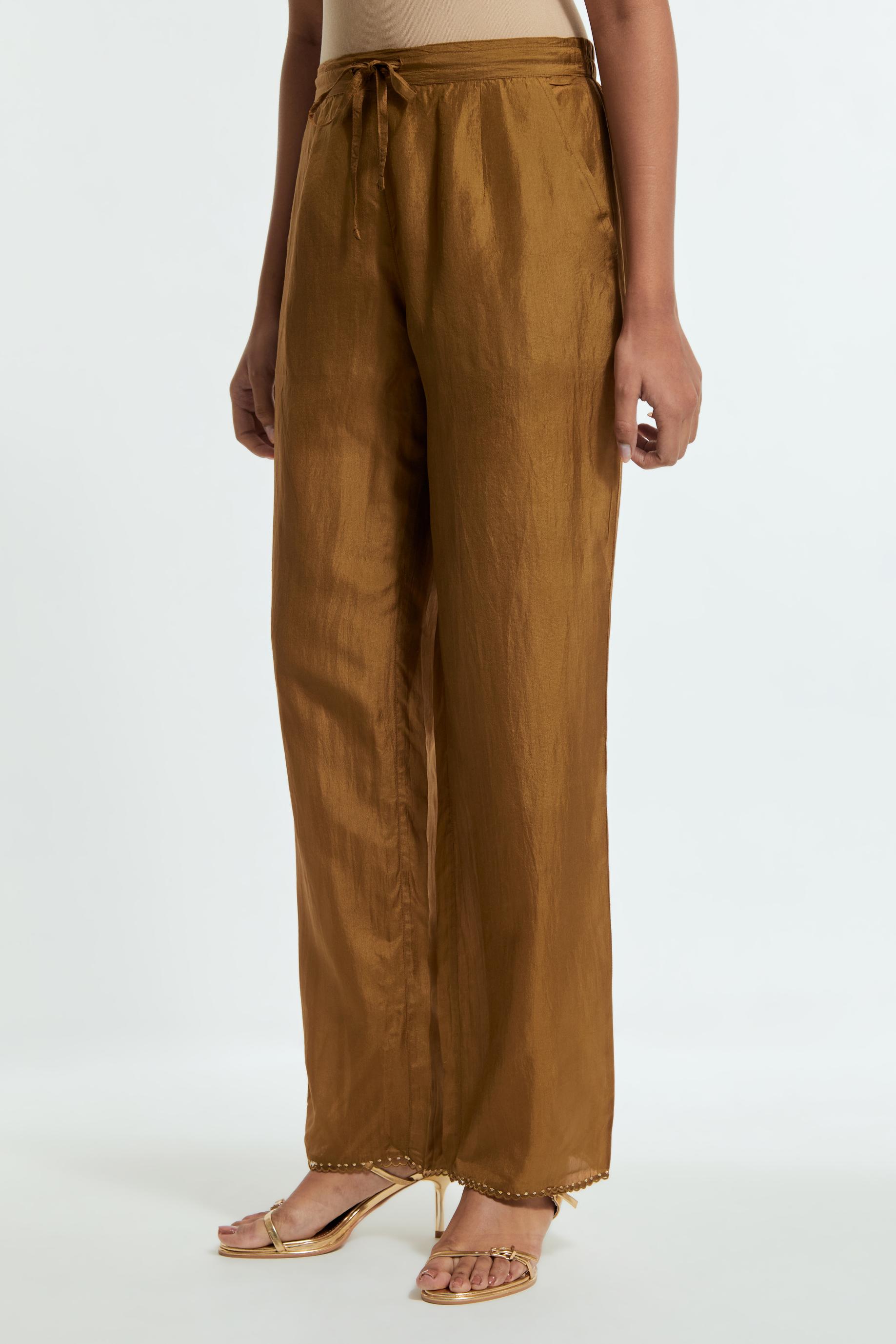 Olive silk straight pants detailed with scalloped organza edging at the hem, delicately highlighted with gold sequins work.