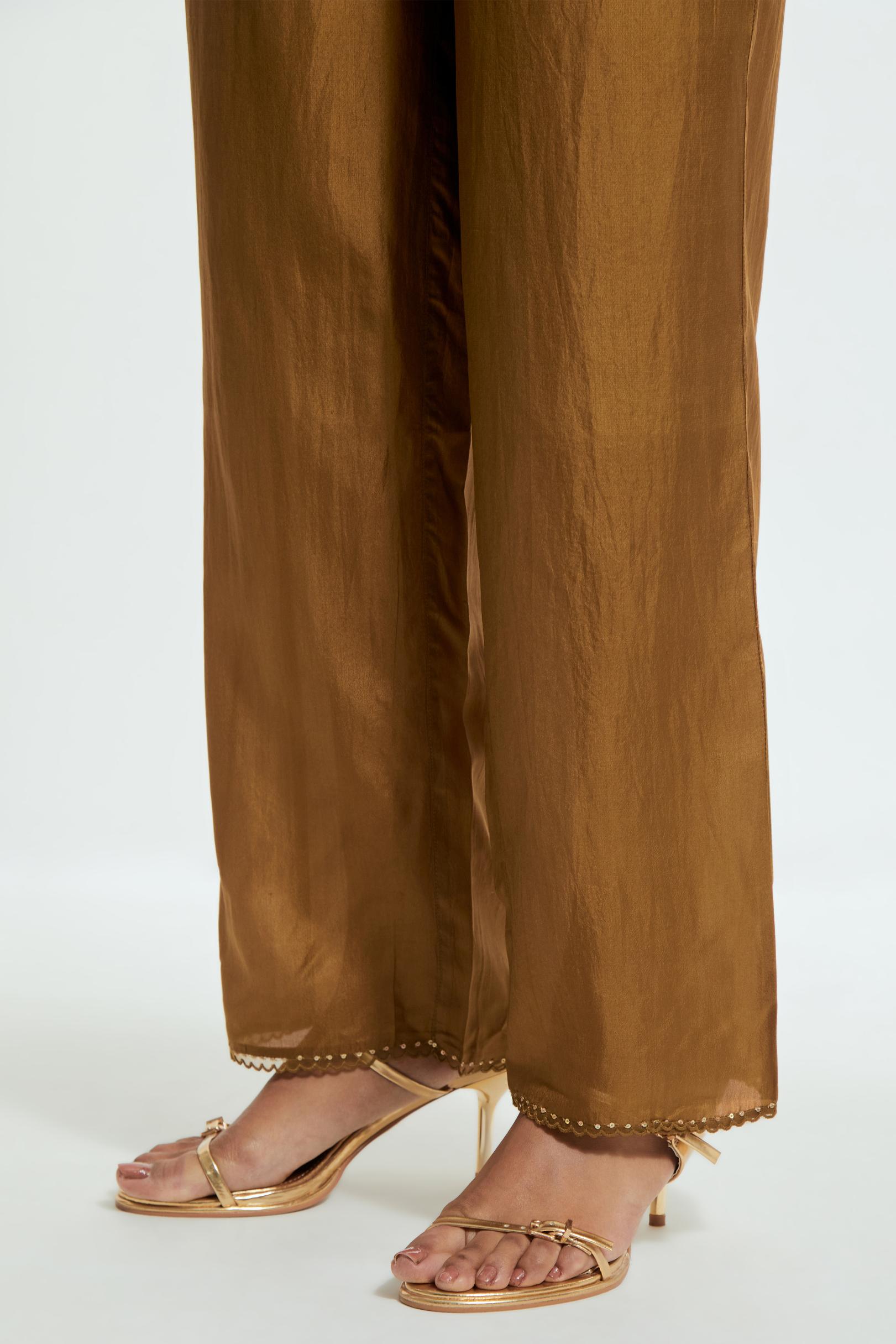 Olive silk straight pants detailed with scalloped organza edging at the hem, delicately highlighted with gold sequins work.