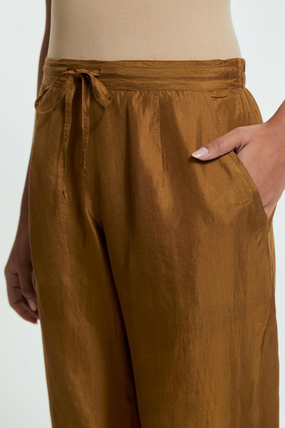 Olive silk straight pants detailed with scalloped organza edging at the hem, delicately highlighted with gold sequins work.