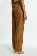 Olive silk straight pants detailed with scalloped organza edging at the hem, delicately highlighted with gold sequins work.