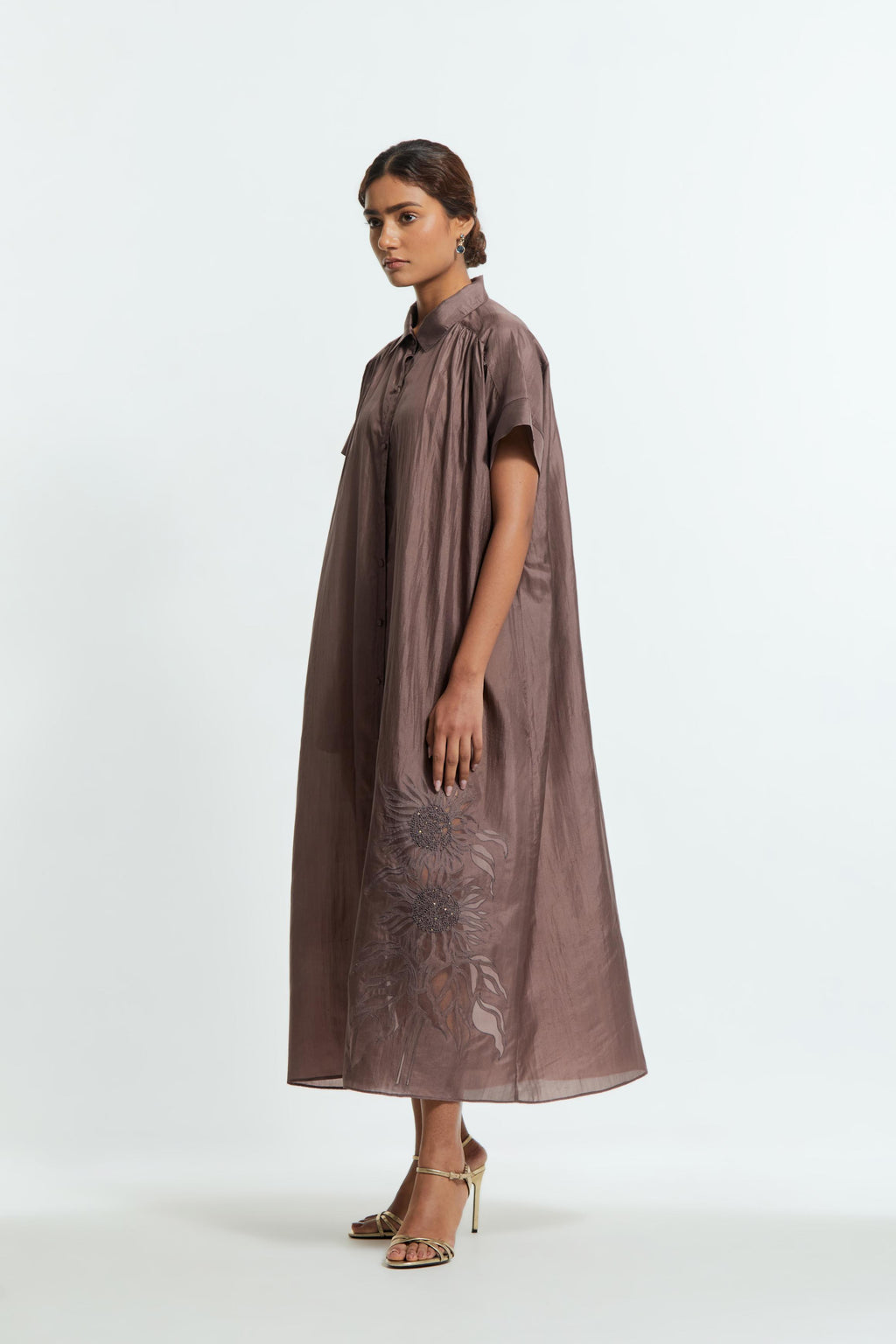 Grey silk long dress adorned with appliqué chrysanthemum floral motifs along one side, delicately highlighted with fine French knots and subtle sequins.
